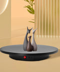 Smooth Electric Rotating Display Stand 360 Degree Turntable With Pure Copper Motor showcasing three decorative sculptures.