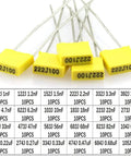 Film Box Capacitor Assortment Kit 240Pcs, Metallized Polyester Capacitors 1nF To 1uF, 24 Values, 63V-100V, showing five yellow capacitors