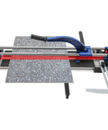 Heavy Duty 24 Inch Manual Tile Cutter For Ceramic And Porcelain Floors Includes Tungsten Blade Ruler And Balancing Rack cutting a gray speckled tile.