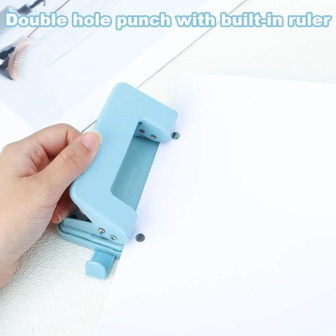 Person using a blue Two Hole Paper Punch Metal Blue Desktop Puncher For File Folders And Loose Leaf Books Beefy Built To Last Heavy Duty