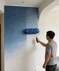 Premium 5 Inch Rubber Patterned Paint Roller Featuring An Ergonomic Handle painting a textured blue wall.