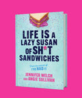 Book cover of 'Life Is A Lazy Susan Of Sh*t Sandwiches' by Jennifer Welch and Angie Sullivan against a pink background.