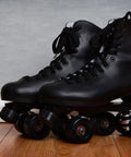 Close-up of black quad roller skates with Adjustable Rubber Toe Stopper For Roller Skates High Elasticity Brake Head Replacement