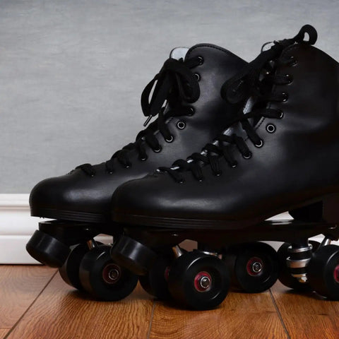 Close-up of black quad roller skates with Adjustable Rubber Toe Stopper For Roller Skates High Elasticity Brake Head Replacement