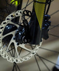 Close-up of a black quick release bicycle skewer on a front wheel, showing One Pair Quick Release Bicycle Skewers Hollow Shaft Axle Set.