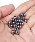 Hand holding 304 Stainless Steel Bearing Balls Kit With 18 Sizes From 1mm To 12.5mm 390 Pcs Assorted Loose Ball Bearings In Plastic Case