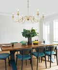 6 Light Gold Finish Chandelier, Vintage Candle Style Farmhouse Ceiling Light in dining room setting with modern rustic decor.