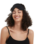 Silk Sleep Mask With Contoured Foam Padding For Light Blocking And No Pressure on woman's forehead, smiling with eyes closed.