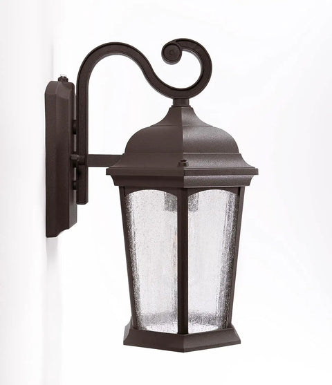 Outdoor Hex Wall Lantern Dusk To Dawn Sensor in Rustic Bronze Cast Aluminum with Seeded Glass Wet Location Rated Photocell Auto.