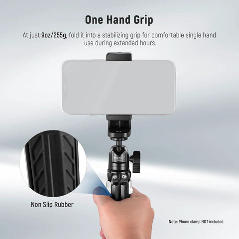 Hand holding Go-To Mini Metal Table Tripod With 360 Degree Ball Head for Camera, marked with non-slip rubber detail.