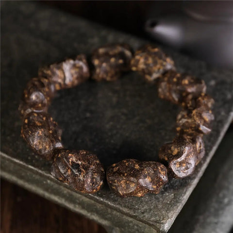 Dope Agarwood Sinensis Jewelry Unisex Adjustable Bracelet with Natural Burl Patterns on Dark Stone Surface
