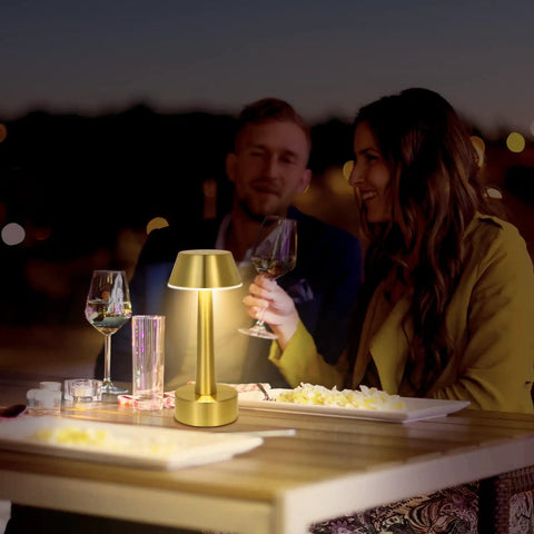 Cordless Gold Battery Operated Table Lamp For Dining Ambience on outdoor table with two people dining at night