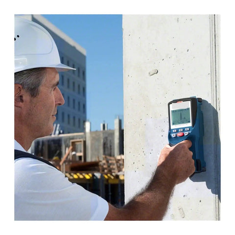 Heavy Duty Handheld Wall Scanner And Stud Detector used by a worker on a concrete wall to locate wood studs and metal pipes.