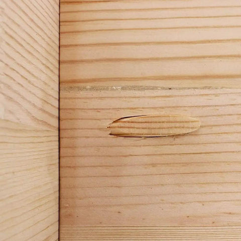 Solid Core 50 Pack 3/8 Inch Pine Pocket Hole Plugs For Diy Carpentry And Furniture Repairs installed in wood, concealing gap.