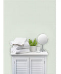 Badass Country Sage Green Matte Linen Wallcovering Pvc Free Heavy Duty Covering in a bathroom setting with towels and plant.