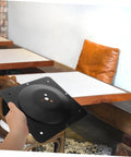 Built Different Square Metal Table Leg Connectors Quick Snap Fit Design For Reliable Sofa And Bench Hardware Straight Setup Heavy Duty Black Iron Furniture Mounting Plates in a hand.