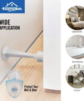 Hefty Zinc Die Cast Door Stops Four Pack With Soft Rubber Buffers Knockout Drywall Defender on a wall near a wooden floor.