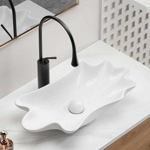 HAOCHRYSYPH Ceramic Shell Vessel Sink Bowl, Milk White, 24.41x13x4.73 in. above-counter bowl with modern black faucet.