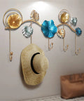 Rock Tight Wrought Iron Wall Hook For Sleek Nordic Style And Snug Door Storage That Locks In Keys Bags And Jackets Without A Sweat While Serving Heavy Duty Swag On Your Front Porch, featuring decorative floral design with hat.