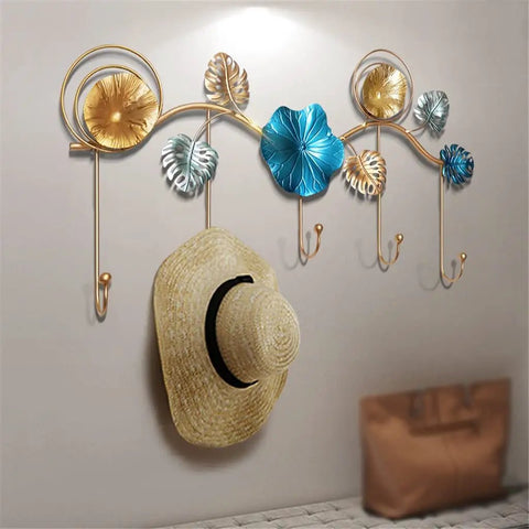 Rock Tight Wrought Iron Wall Hook For Sleek Nordic Style And Snug Door Storage That Locks In Keys Bags And Jackets Without A Sweat While Serving Heavy Duty Swag On Your Front Porch, featuring decorative floral design with hat.