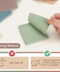 Hand peeling a green sticky note from Sticky Notes 3x3 Self Stick Pads With 8 Morandi Colors For Office School And Home, showing tear method.