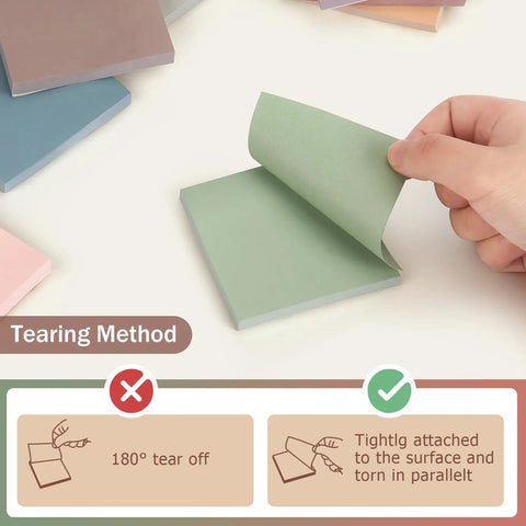 Hand peeling a green sticky note from Sticky Notes 3x3 Self Stick Pads With 8 Morandi Colors For Office School And Home, showing tear method.
