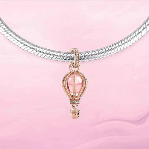 Pink Hot Air Balloon Charm in rose gold plating for bracelets with cubic zirconia and pink crystal accents on a necklace.