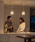 Brushed Gold Crystal Pendant Light With Adjustable Rods And Sloped Ceiling Mount No Sweat Install Super Smooth Hang Straight Up Elegant Lamp For Kitchen Island Dining Space E26 Base illuminating a couple in a warm dining setting.