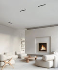 No Hassle 15W Linear Recessed Downlight With Sleek Black Trim delivers smooth lighting above modern living room with white ceiling.