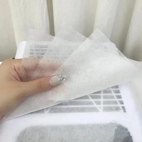 Hand holding 100 Pack Disposable Nonwoven Filter Cloths for Nail Vacuum Cleaners Nail Art Dust Collector Replacements