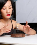 Person interacting with Levitating Bulb Lamp With Magnetic Floating Light For Home Office And Desk Decor A Totally Cool Tech Gadget Gift For Him And Her Perfect Valentine Gift For Him And Her Or Christmas Birthday Present, featuring a floating light bulb above a wooden base on a desk.