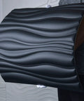 Holding a Dope 3D Leather Wall Tiles Set 6 Pack Black Wave Panels 23.6 Inch Square Each, Covers About 23.25 Sq Ft