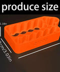 Ergonomic Battery Welding Jig For 18650 And 21700 Cells With Insulated Safety Clamps Quick Spotting Fixture shown in orange color with size markings.