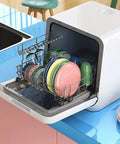 Compact Countertop Dishwasher Packs Six Place Settings And Five Wash Cycles To Get Dishes Done Quick Featuring Steam Baby Sterilizer Auto Air Dry And Smart LED Interface Ideal For Tight Apartments with plates and glasses loaded.