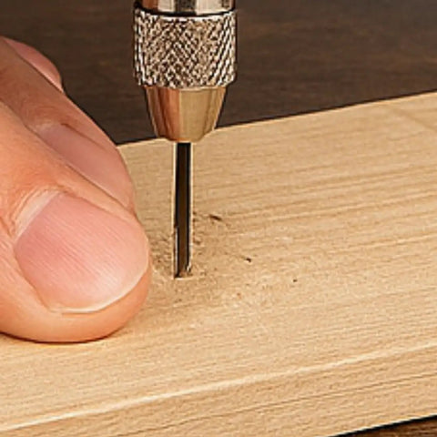 Close-up of pin vise with swivel ball head in use, 4 inch length, showing adjustable chuck on wood. Useful for setting, reaming, and tapping.
