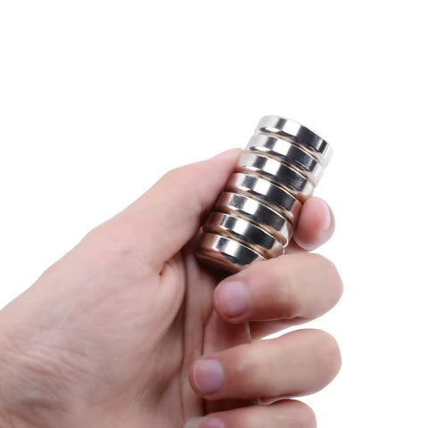 Hand holding Beast Mode Heavy Duty Neodymium Round Base Cup Magnets 60 Pieces With Holes Countersunk Discs 60 Lbs Pull