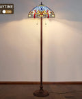 Blue Tiffany Style Floor Lamp 64 Inch Tall With Stained Glass Shade Durable Resin And Aluminum Base Includes Two 2700K E26 LED Bulbs Retro Pull Chain Gift Ready To Elevate Your Living Room Or Bedroom Vibe displayed in daytime setting.