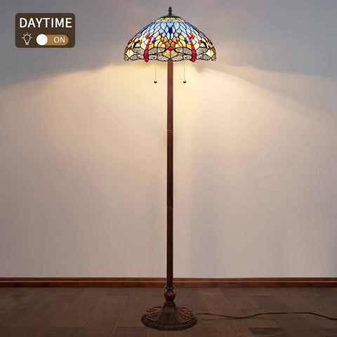 Blue Tiffany Style Floor Lamp 64 Inch Tall With Stained Glass Shade Durable Resin And Aluminum Base Includes Two 2700K E26 LED Bulbs Retro Pull Chain Gift Ready To Elevate Your Living Room Or Bedroom Vibe displayed in daytime setting.