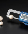 Electronic Pearl Caliper, 0.01-25mm Digital Gauge Measure Tool, for Gemstones, Pearls, Diamonds measuring a pearl size.