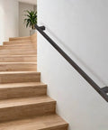 Heavy Duty Black Wrought Iron Stair Railing With Tough As Nails Build And Slick Non Slip Grip Adjustable From Thirty To Six Hundred Centimeters For Rock Solid Support And Badass Wall Decor mounted on a wall beside wooden stairs.