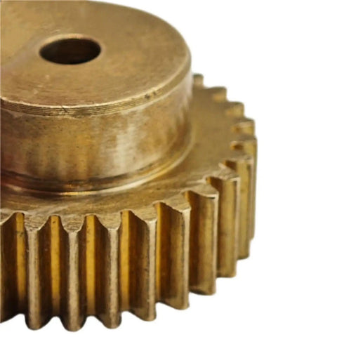 Close-up of a 0.75 Module Copper Cylindrical Spur Gear 43 Teeth 15mm Bore With Step Mechanical Pinion Shaft Hardware