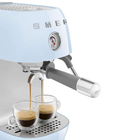 Totally Iconic Retro Espresso Maker With Cold Brew Feature, Packin 15 Bars Of Pressure, Smooth Operation Steam Wand, Exact Temp Control, Huge 47 Oz Tank In Chill Pastel Blue brewing espresso into two glasses.