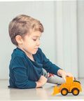 Child playing with 4 Piece Front End Loader Plastic Engineering Vehicle Models for Compact Construction Trucks built for kids