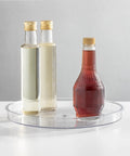 Slick Rotating Lazy Susan Turntable Spinner Fully Swiveling 11.5 Inch Clear Plastic Round Organizer with sauces.