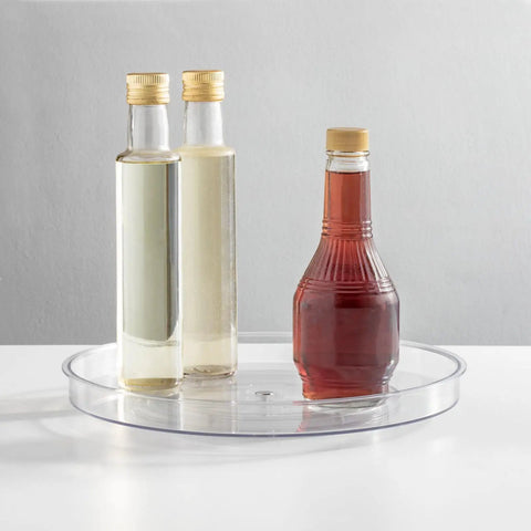 Slick Rotating Lazy Susan Turntable Spinner Fully Swiveling 11.5 Inch Clear Plastic Round Organizer with sauces.