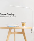 Space Saving Clip On Desk Lamp With Clamp USB Gooseneck Reading Light attached to desk with books and coffee cup.