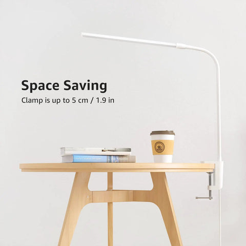 Space Saving Clip On Desk Lamp With Clamp USB Gooseneck Reading Light attached to desk with books and coffee cup.