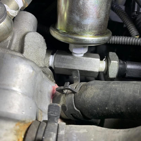 Stainless steel 1/8 NPT oil pressure sensor tee adapter installed on engine with hose fittings
