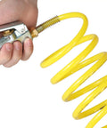 Hand holding Coiled Nylon Air Hose With Brass 1/4 Inch NPT Fittings, Anti Corrosion And Abrasion Resistant, yellow coil visible