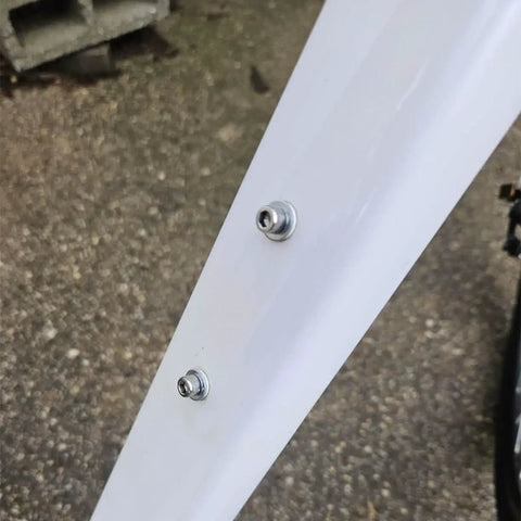Close-up of bike frame with 10 Pack M5 Bike Water Bottle Cage Bolts Screws Set Hex Head Stainless Steel Inner Rack Mount Hardware.